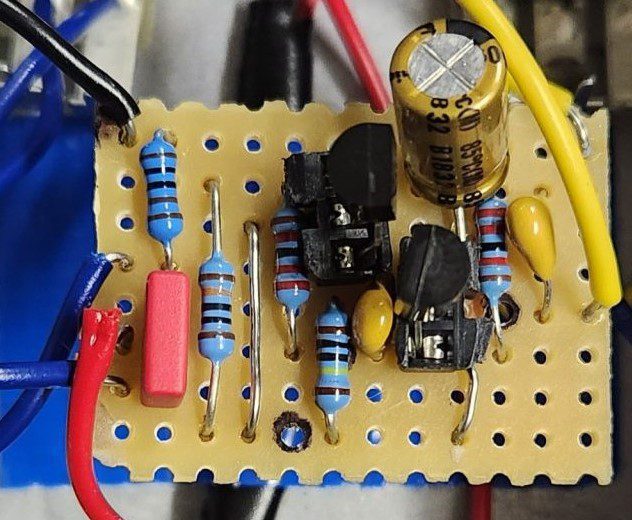 Example of a piece of stripboard populated with various components to make a guitar pedal.